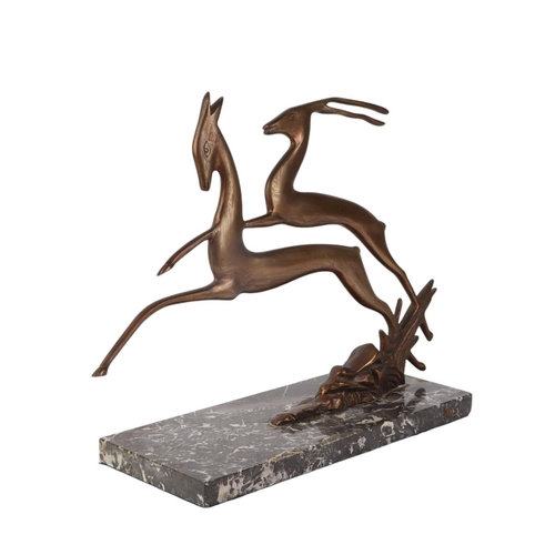 303 - An Art Deco bronze figure of two leaping deer, on a figured marble base, 28cms high.