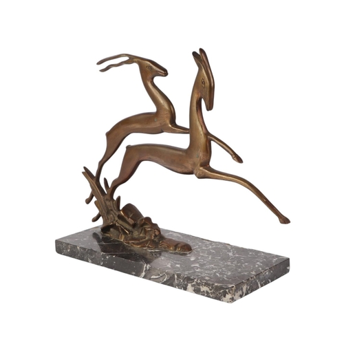 303 - An Art Deco bronze figure of two leaping deer, on a figured marble base, 28cms high.