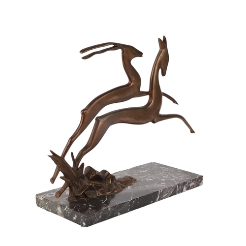 303 - An Art Deco bronze figure of two leaping deer, on a figured marble base, 28cms high.