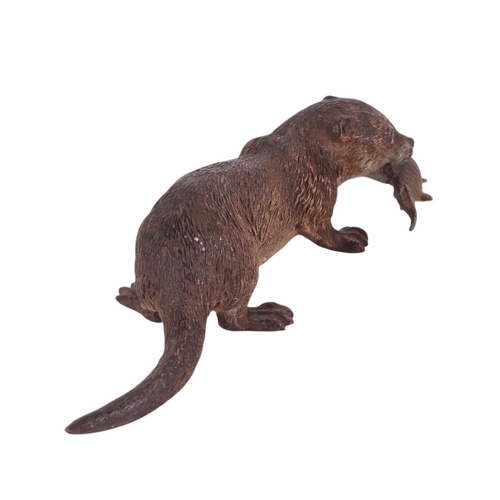 306 - A large Vienna cold painted bronze figure of an otter with a fish in its mouth, 17.5cms long.