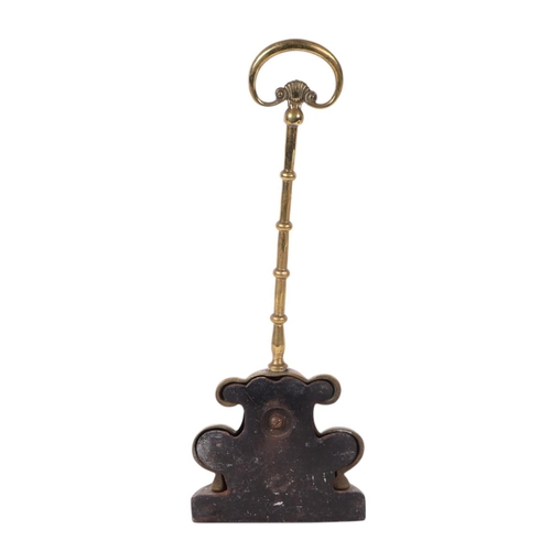 309 - A 19th century Victorian brass doorstop with a hoop handle and knopped stem above a scrolling base a... 