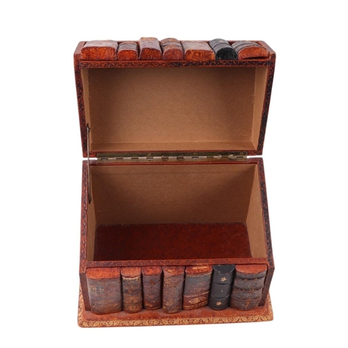 310 - A gilt tooled Moroccan leather box in the form of a run of books, 26cms wide.