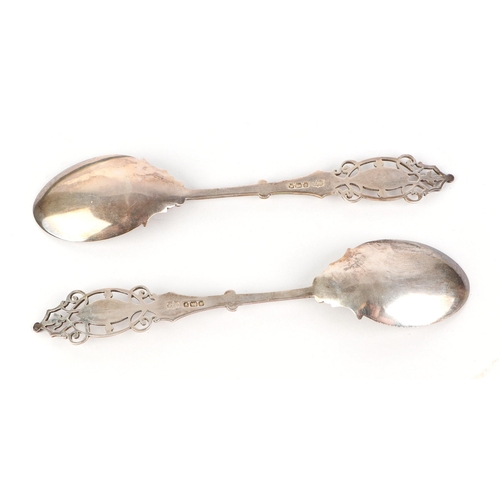 409 - A pair of Edwardian ornate pierced and engraved silver preserve spoons in original fitted case, Shef... 