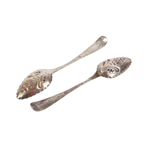 411 - A pair of early 19th century ornate silver berry spoons, Dublin 1803 and makers mark for Samuel Nevi... 