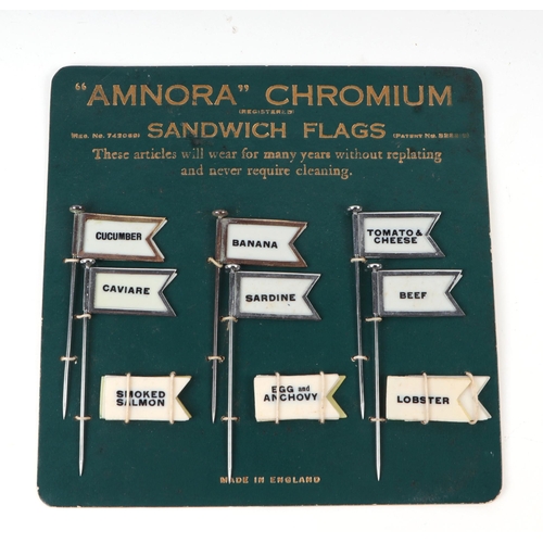 417 - A set of Art Deco Amnora chromium sandwich flags, on original cardboard back board, six flags and tw... 