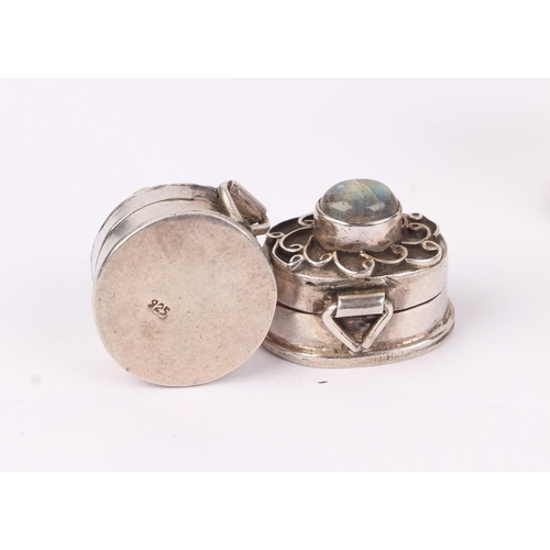 418 - Four cabochon gem set 925 silver pill boxes, the largest 2.5cms wide; together with a similar white ... 