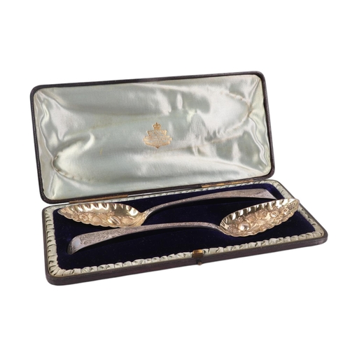 426 - A pair of ornate embossed silver berry spoons, London 1808, in a fitted velvet line presentation box... 