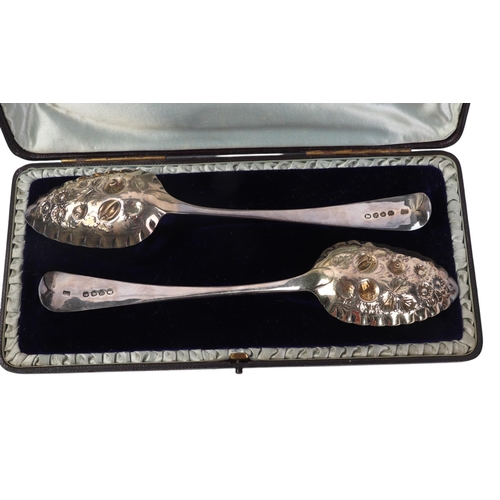 426 - A pair of ornate embossed silver berry spoons, London 1808, in a fitted velvet line presentation box... 