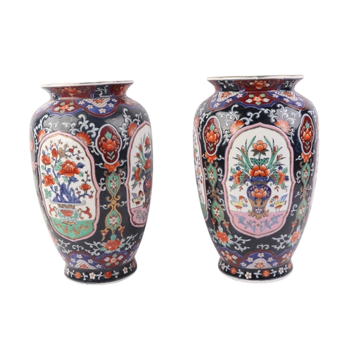 43 - A pair of Japanese style vases decorated with flowers, drilled, 31cms high (2).