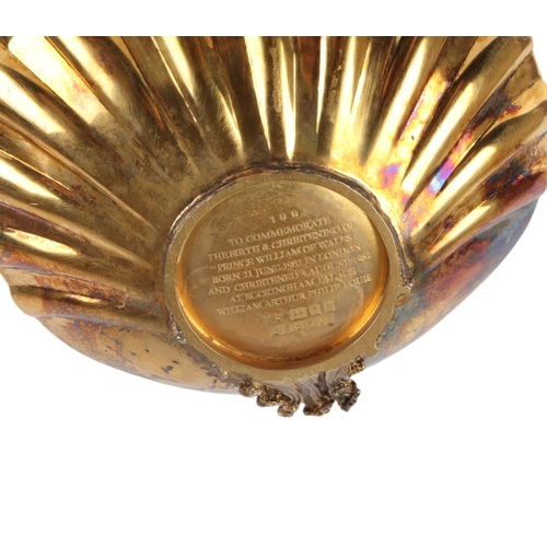 432 - A silver gilt shell shaped dish with winged cherub decoration, London 1982, produced by Aurum to com... 