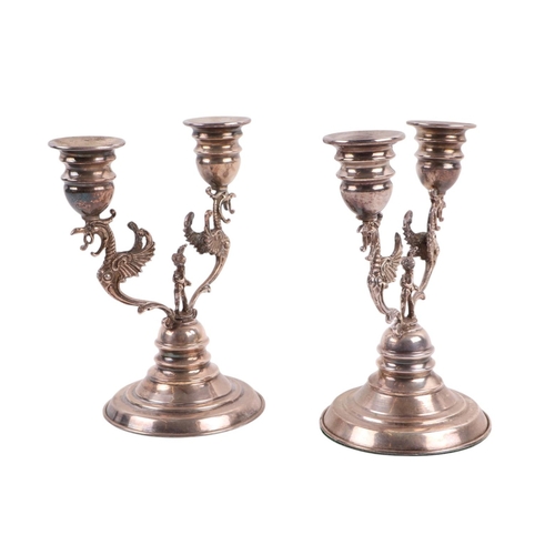 454 - A pair of twin branch continental silver candlesticks, marked '925' to both, 15cms high (weighted ba... 