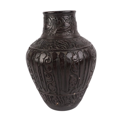 46 - A continental Persian influenced pottery vase, impressed to the underside '54' and 'B', 29cms high.