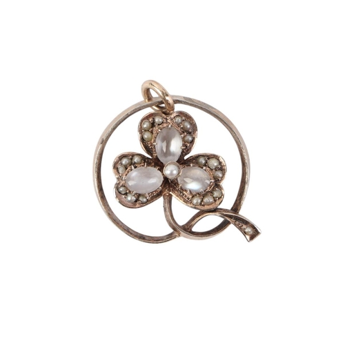 474A - An early 20th century silver gilt moonstone and seed pearl pendant.