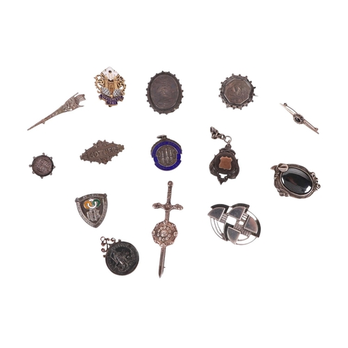 476 - A quantity of silver brooches and fob pendants to include an 1886 Swiss gold mounted example, 132g.