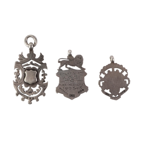 493 - Three silver pocket watch fobs, 31g; together with a white metal mounted porcelain fragment pendant,... 