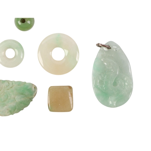 509 - A quantity of Chinese jade / hardstone pendants and discs.