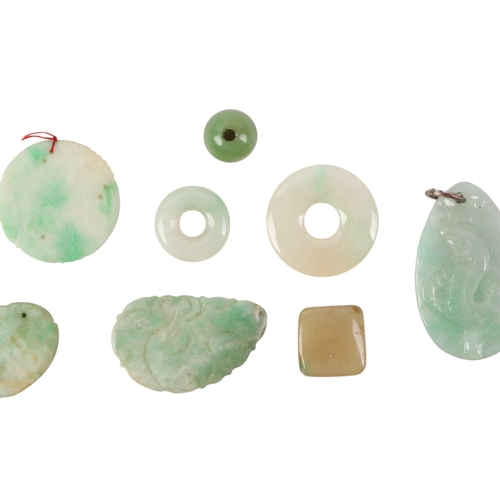 509 - A quantity of Chinese jade / hardstone pendants and discs.