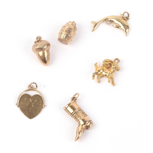 514 - Four 9ct gold charms to include a boot and an acorn, 3.4g; together with two other charms.