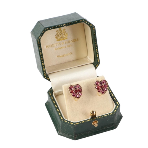 524 - A pair of Victorian 9ct gold heart shaped ruby set screw-back earrings, 2g.