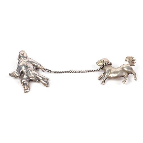 549 - A Chinese silver double brooch in the form of a man with a dog on a lead; together with a silver col... 