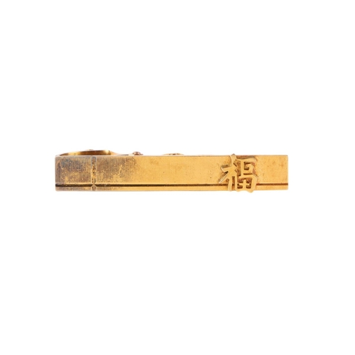 558 - A pair of Chinese gold cufflinks and matching tie clip, marked 14k, gross weight 17g.