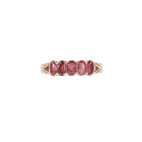 561 - A 9ct gold ring set with five pale amethyst / garnets, approx UK size P, 2.8g.