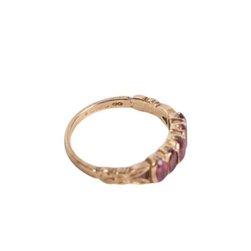 561 - A 9ct gold ring set with five pale amethyst / garnets, approx UK size P, 2.8g.