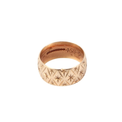 563 - A 9ct gold wide wedding band with engraved decoration, approx UK size L, 4.7g.