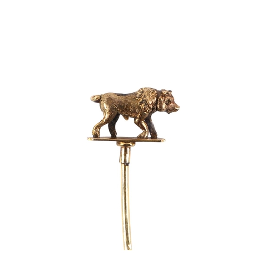 569 - A Victorian yellow metal stick pin, the terminal in the form of a bull, 7cms long, 3g.