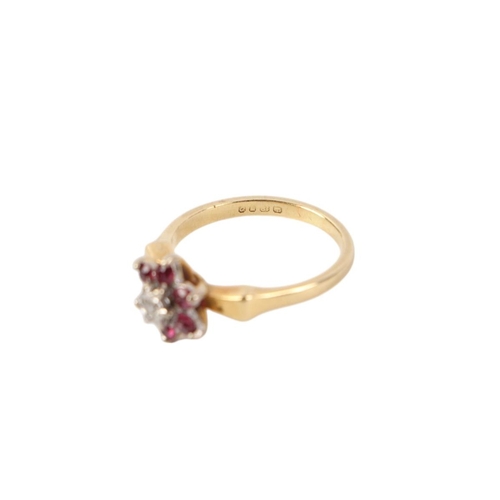 572 - An 18ct gold ruby and diamond flowerhead ring, approx UK size I 1/2, 3.1g.