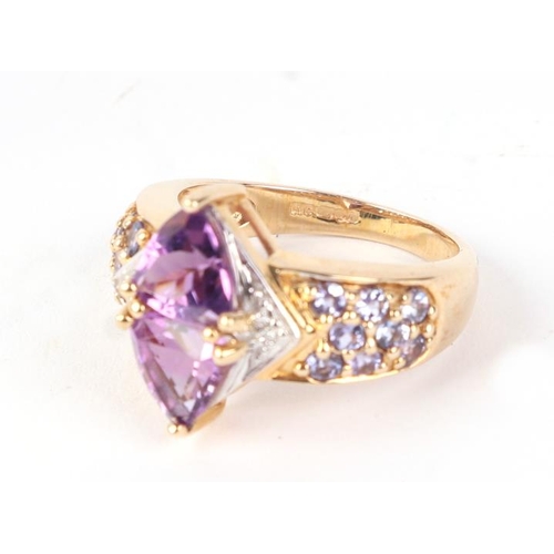 579 - A 9ct gold amethyst and diamond dress ring, approx UK size L, 4.2g.