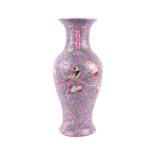 584 - A Chinese China Straights style vase of baluster form decorated birds and foliage on a purple ground... 