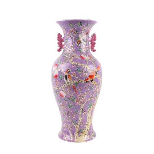 584 - A Chinese China Straights style vase of baluster form decorated birds and foliage on a purple ground... 