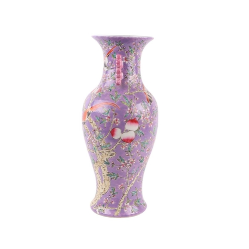 584 - A Chinese China Straights style vase of baluster form decorated birds and foliage on a purple ground... 