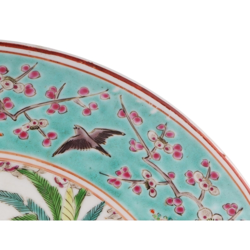 589 - A Chinese famille rose China Straits style plate, the central vignette decorated with a scholar and ... 