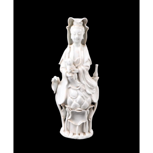 596 - A Chinese blanc de chine figure depicting Guanyin, 22cms high.