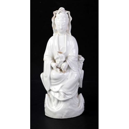 605 - A Chinese blanc de chine figure depicting Guanyin, 25cms high (a/f).