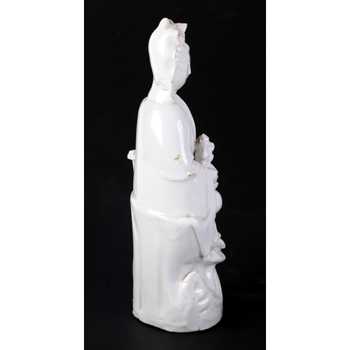 605 - A Chinese blanc de chine figure depicting Guanyin, 25cms high (a/f).