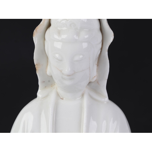 605 - A Chinese blanc de chine figure depicting Guanyin, 25cms high (a/f).