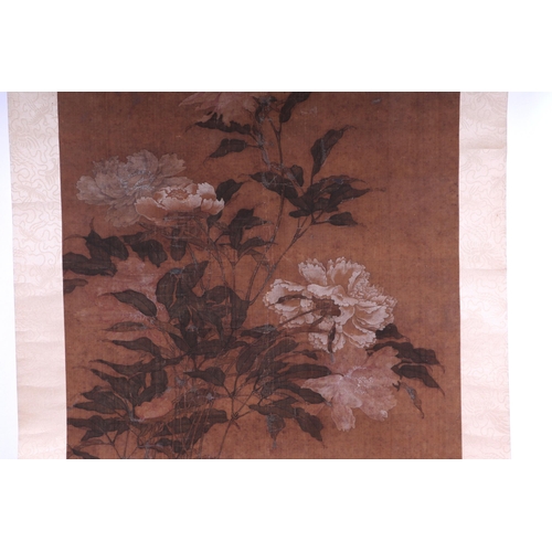 609 - A Chinese scroll painting depicting peonies, overall 60 by 151cms.