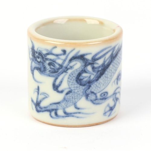 610 - A Chinese blue & white pottery archer's ring decorated with a dragon, two character blue mark to the... 