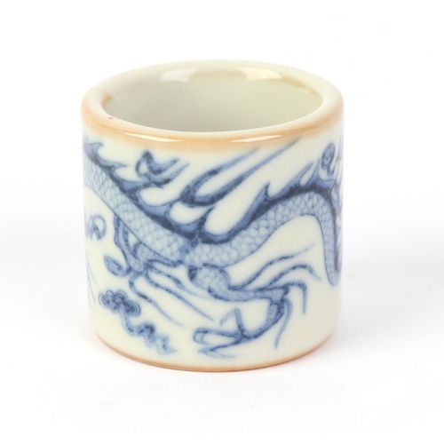 610 - A Chinese blue & white pottery archer's ring decorated with a dragon, two character blue mark to the... 