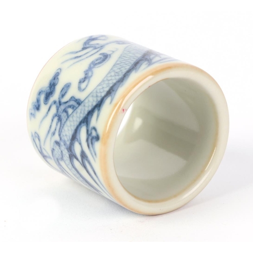 610 - A Chinese blue & white pottery archer's ring decorated with a dragon, two character blue mark to the... 