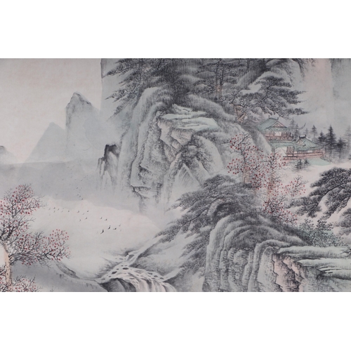 612 - A Chinese scroll depicting a mountainous landscape scene with calligraphy, 62 by 127cms.