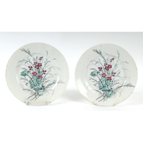 613 - A pair of Chinese famille rose plates decorated with flowers, 23cms diameter (2).