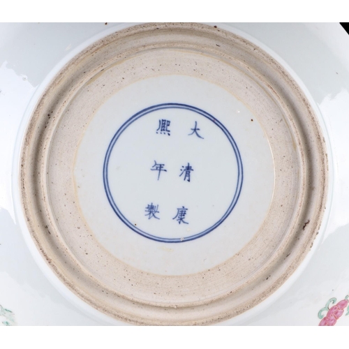 615 - A large Chinese famille rose shallow footed bowl decorated with flowers within panels, six character... 