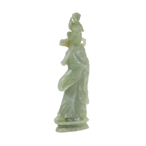 617 - A figured green hardstone figure depicting Guanyin, 24cms high.