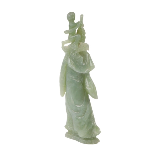 617 - A figured green hardstone figure depicting Guanyin, 24cms high.