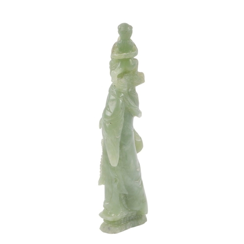 617 - A figured green hardstone figure depicting Guanyin, 24cms high.