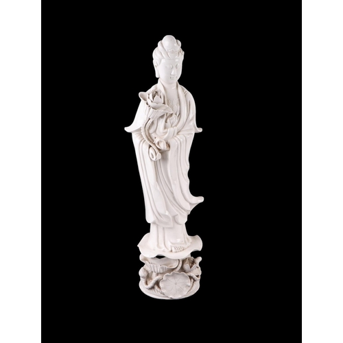 618 - A Chines blanc de chine figure depicting Guanyin standing on a lily pad, 47cms high.